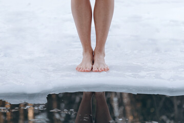 girl legs getting into ice cold water