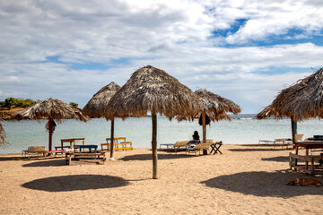 Beach chairs with umbrella and beautiful sand beach in Cuba
