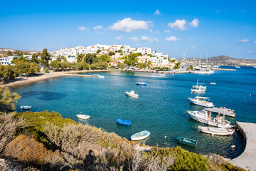 View of Idyllic beach in Adamas port bay with fishing boats on sea, Milos island, Cyclades, Greece