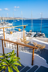 View of Adamas port with boats from terrace of restaurant bar, Milos island, Cyclades, Greece