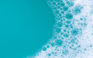 Detergent foam bubble on water. Blue background, Soap sud