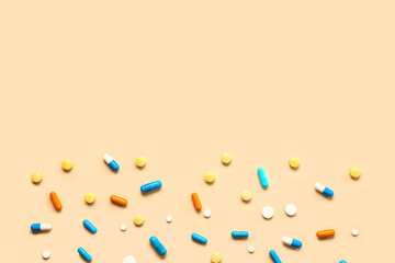 Many different pills on orange background