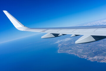 Fototapeta na wymiar Scenic aerial shot capturing the airplane wing gliding above Portugal's stunning coastal landscape.