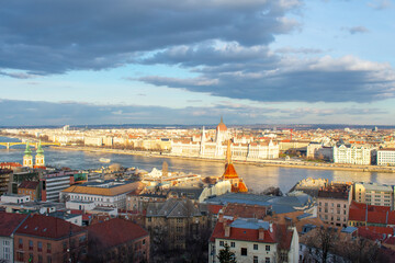 Aerial view on Parliament building, Danube River and City at sunset in Budapest, Hungary. High angle view of buildings and town