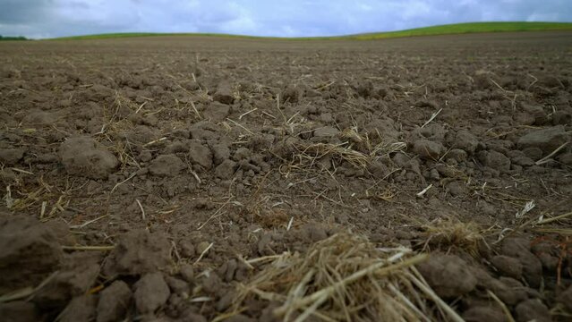 Close-Up on Ploughed Farmland. Detailed view of dry, cloddy soil on plowed agricultural field.