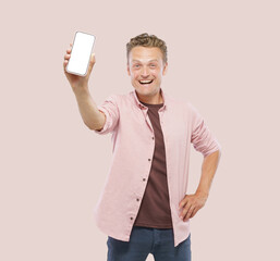 A man is holding a white cell phone in his hand and smiling. Concept of happiness and excitement, as the man is posing with the phone, possibly to share a moment or a photo with friends or family