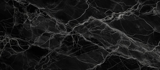A detailed view of a smooth black marble surface with a distinct white line running through it