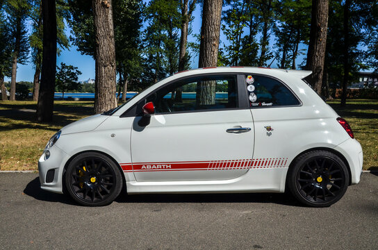 White Abarth 595 two-door, front-wheel-drive saloon produced by Italian automaker Fiat parked at the city 