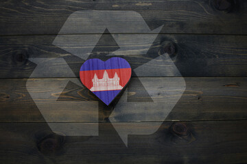 wooden heart with national flag of cambodia near reduce, reuse and recycle sing on the wooden...