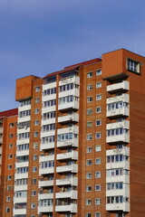Fototapeta premium Looking up to red (orange) brick with many windows, Lasnamae, Tallinn, Estonia, Europe. 2024