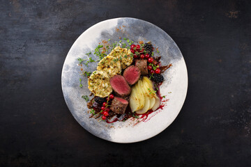Traditionally roasted saddle of venison fillet with South Tyrolean bread dumplings, berries and...
