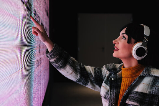 Wheelchair User Interacting with Touchscreen Art Exhibit