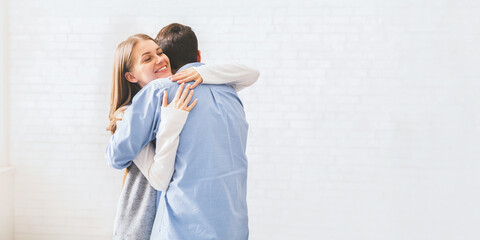 Happy spouses cuddling each other after group meeting with relationship therapist.