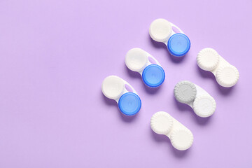 Containers for contact lenses on lilac background