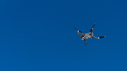 quadcopter flies in blue sky