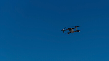 quadcopter flies in blue sky