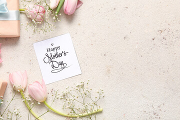 Card with text HAPPY MOTHER'S DAY, gift box and beautiful flowers on light background