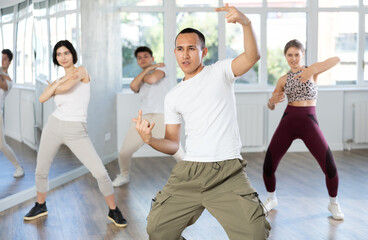 Team of dancers performing swing dance in ball room
