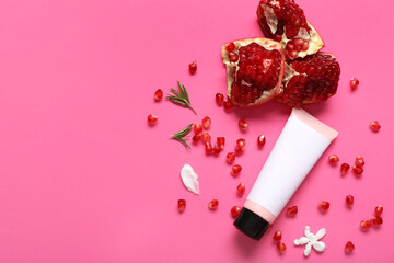 Composition with tube of cosmetic product and ripe pomegranate on color background