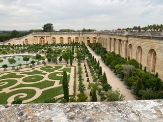 Gardens of Versaille with Orangerie  meticulously manicured lawns  precise geometric patterns
