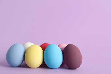 Painted Easter eggs on purple background
