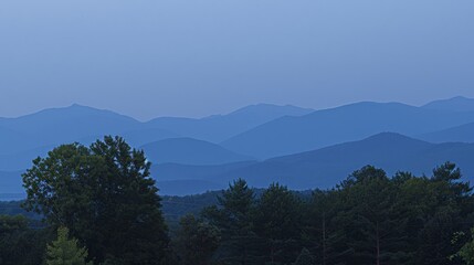  a plane flying over a lush green forest under a blue sky with a mountain range in the distance in the distance.