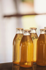 lots of bottles with home made apple juice. Reusable glasses bottle with freshly made apple juice or cider. 