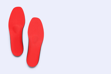 Red comfortable orthopedic insoles isolated on white background