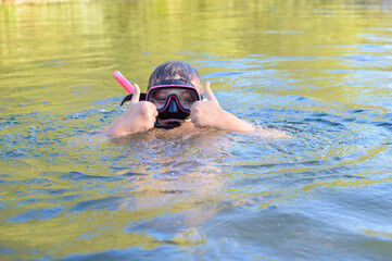 Boy in a mask diving in the water