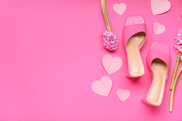 Female shoes with hyacinth flowers and paper hearts on pink background