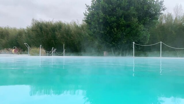 Hot water thermal springs with sulphur concentration vapouring in cold cloudy day, sulphur water with healing properties and benefits for human body, steaming sulphur with antivirus, anticancer and