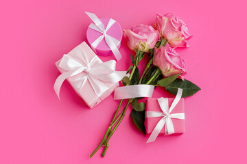 Gift boxes and beautiful roses on pink background