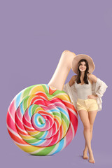 Smiling young woman with inflatable mattress on lilac background
