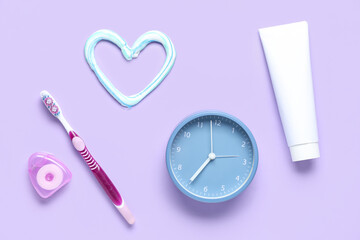 Heart made of toothpaste, clock, dental floss and toothbrush on lilac background