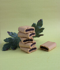 Fig bites on a yellow background with green leave on the back.