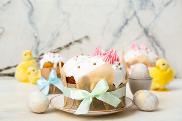 Tasty Easter cakes with eggs and chicks on white background