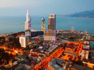 Scenic cityscape of town Batumi with illuminated Alphabetic Tower at spring evening, Georgia