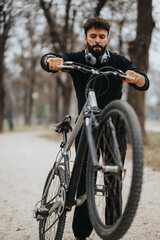 A businessman enjoying a break outdoor, riding a bike in the park while wearing headphones for relaxation.
