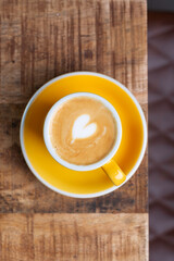 Aromatic Cappuccino with Latte Art Heart in Sunny Yellow Cup