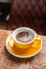Warm Beverage in Yellow Cup on Wooden Table, Aromatic Morning Coffee