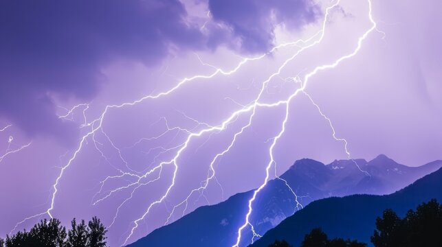  a purple and black photo of a lightning storm with mountains in the back ground and trees in the foreground.