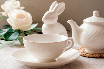 Fototapeta na wymiar easter tea table decoration, porcelain rabbit, teapot, cups, generated with AI 