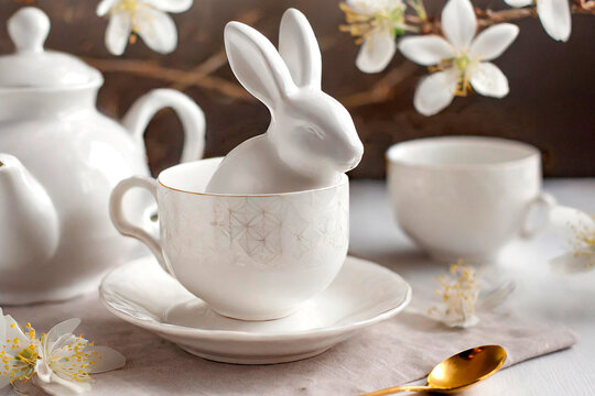 easter tea table decoration, porcelain rabbit, teapot, cups, generated with  AI 