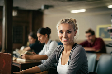 young adult woman is with other people in a classroom or further education