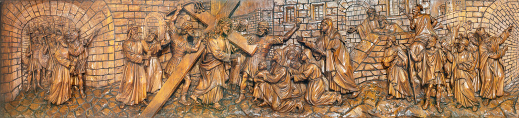 MILAN, ITALY - MARCH 5, 2024: The carved relief  Jesus meets the women of Jerusalem in the church Chiesa di San Camillo by Annibale Pagnoni (1900).