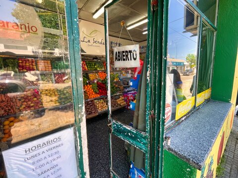 nueva helvecia, uruguay - November 1 2022: the entrance door of a small vegetable store in a small rural town has been painted green