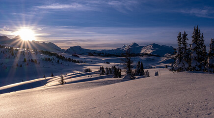 early morning sunburst over fresh snow