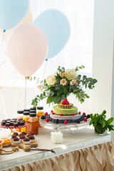 Celebratory Table with Cake, Balloons, and Sweet Treats for a Festive Occasion