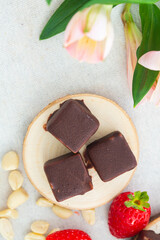 Artisanal Chocolate Treats Paired with Fresh Berries and Nuts on a Textured Background, Organic healthy food
