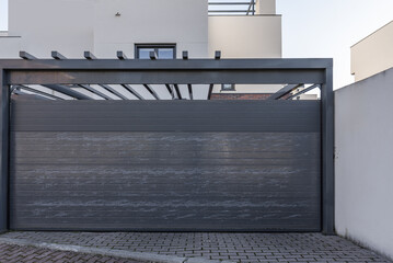 Urbanization with gray folding portals of the garage door